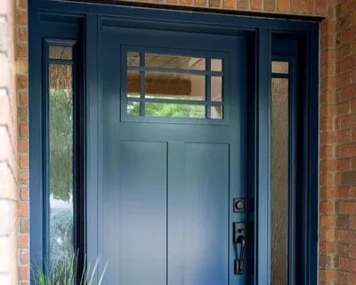 Blue entry door against brick house.