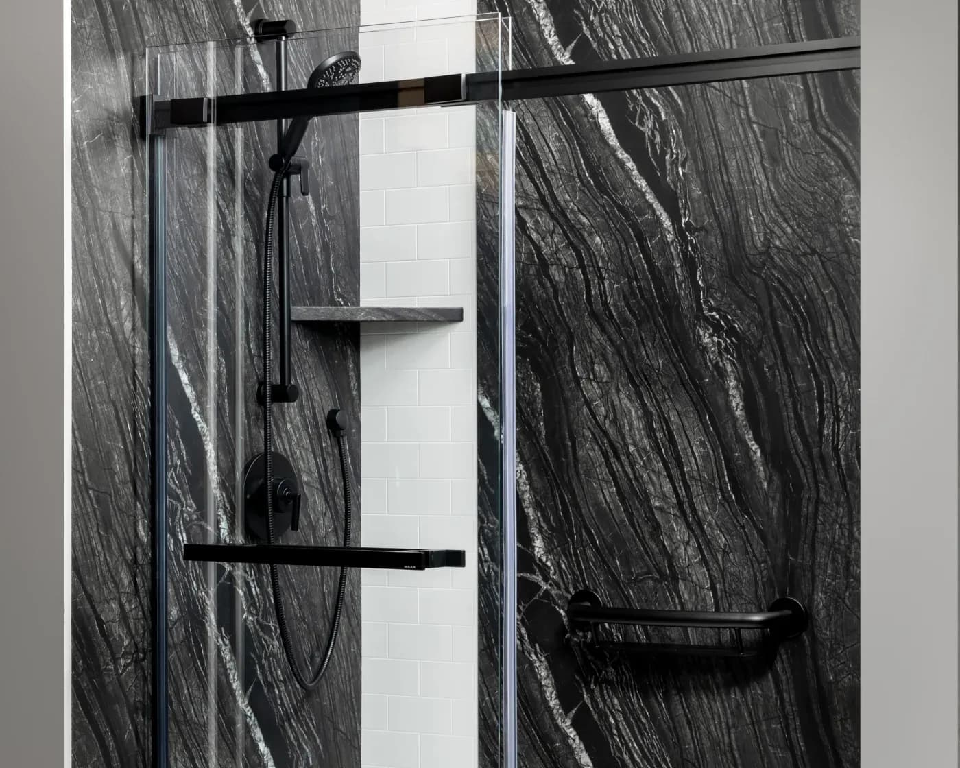 Walk-in shower with ash-colored shower walls.