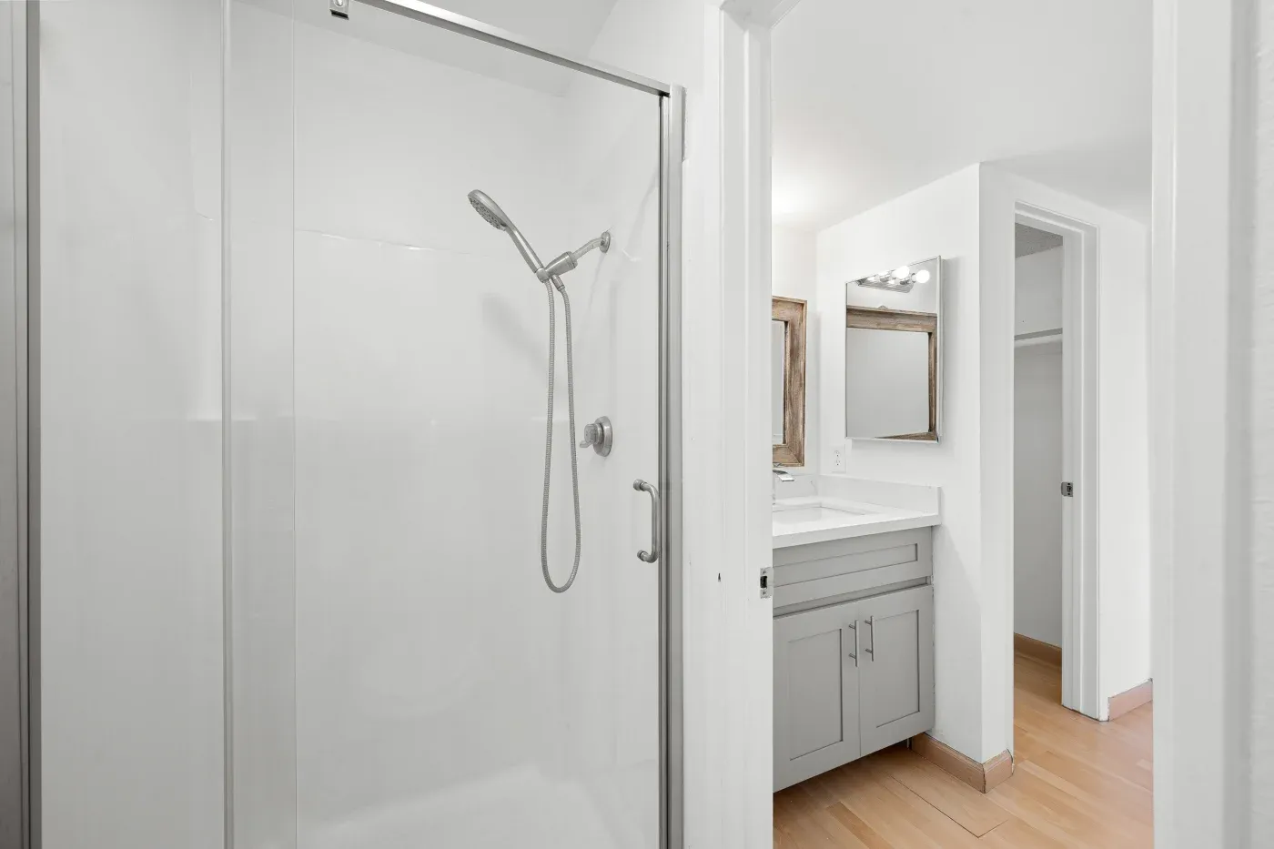 A freshly remodeled bathroom with a walk-in shower, ready to be painted and decorated.