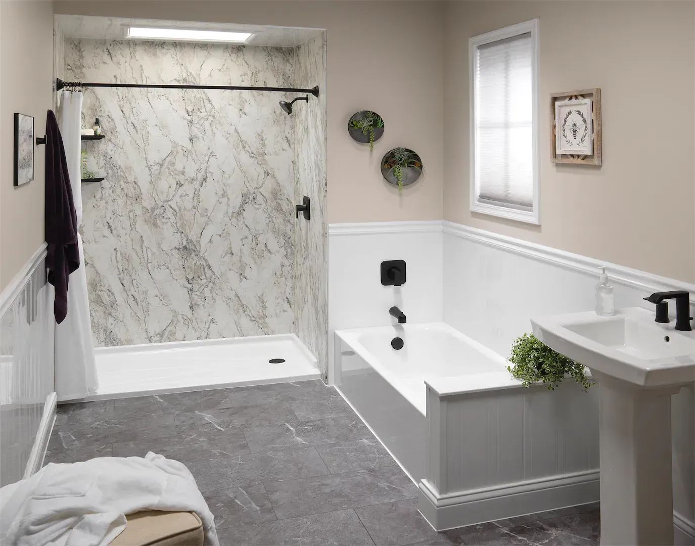 A newly-remodeled bathroom with a walk-in marble shower stall, dark gray tile floor, and a bathtub off to the right side.