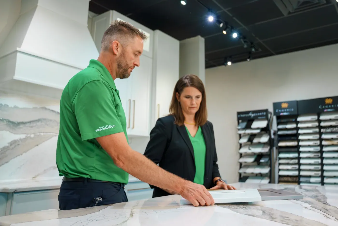 The husband/wife team behind the Ozark Home Pros company in their Springdale design center looking at different materials.