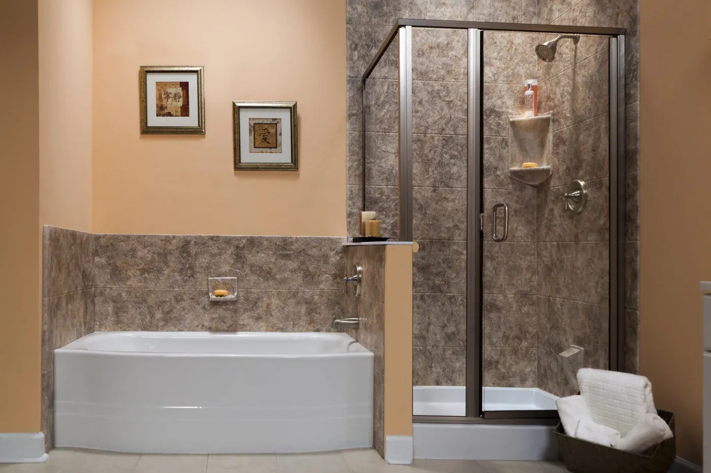 A tan bathroom with white bathtub and a walk-in shower stall to the right.
