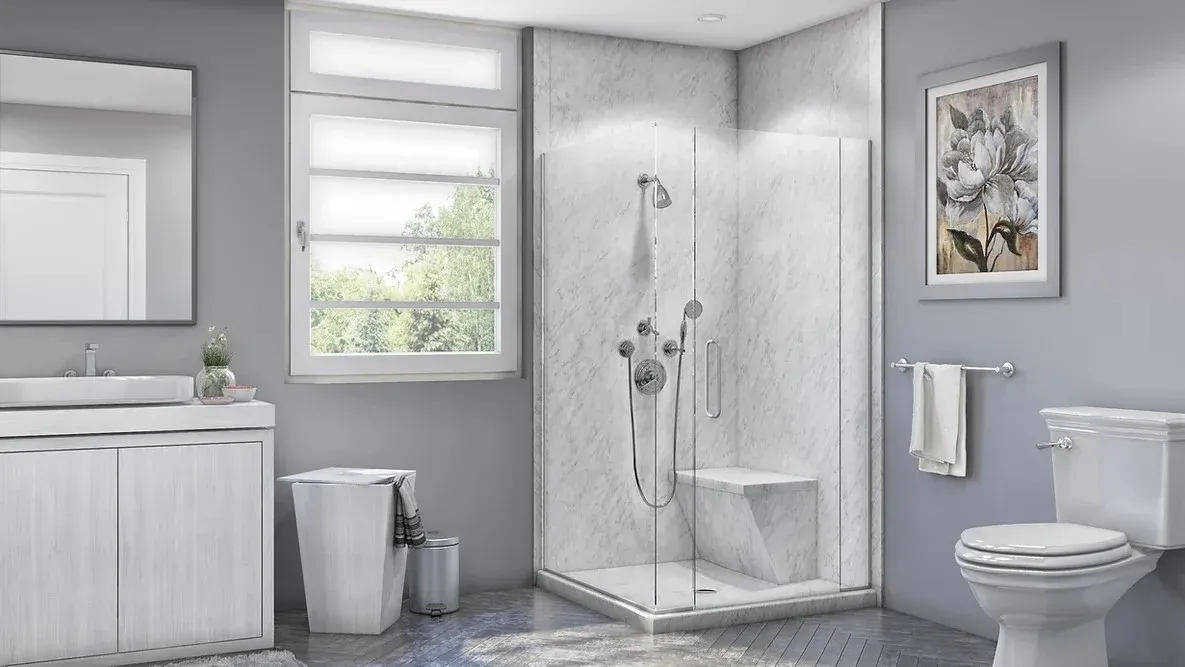 A newly remodeled bathroom with a beautiful new walk-in shower installed by Ozark Home Pros with glass walls, a seat, and chrome hardware.